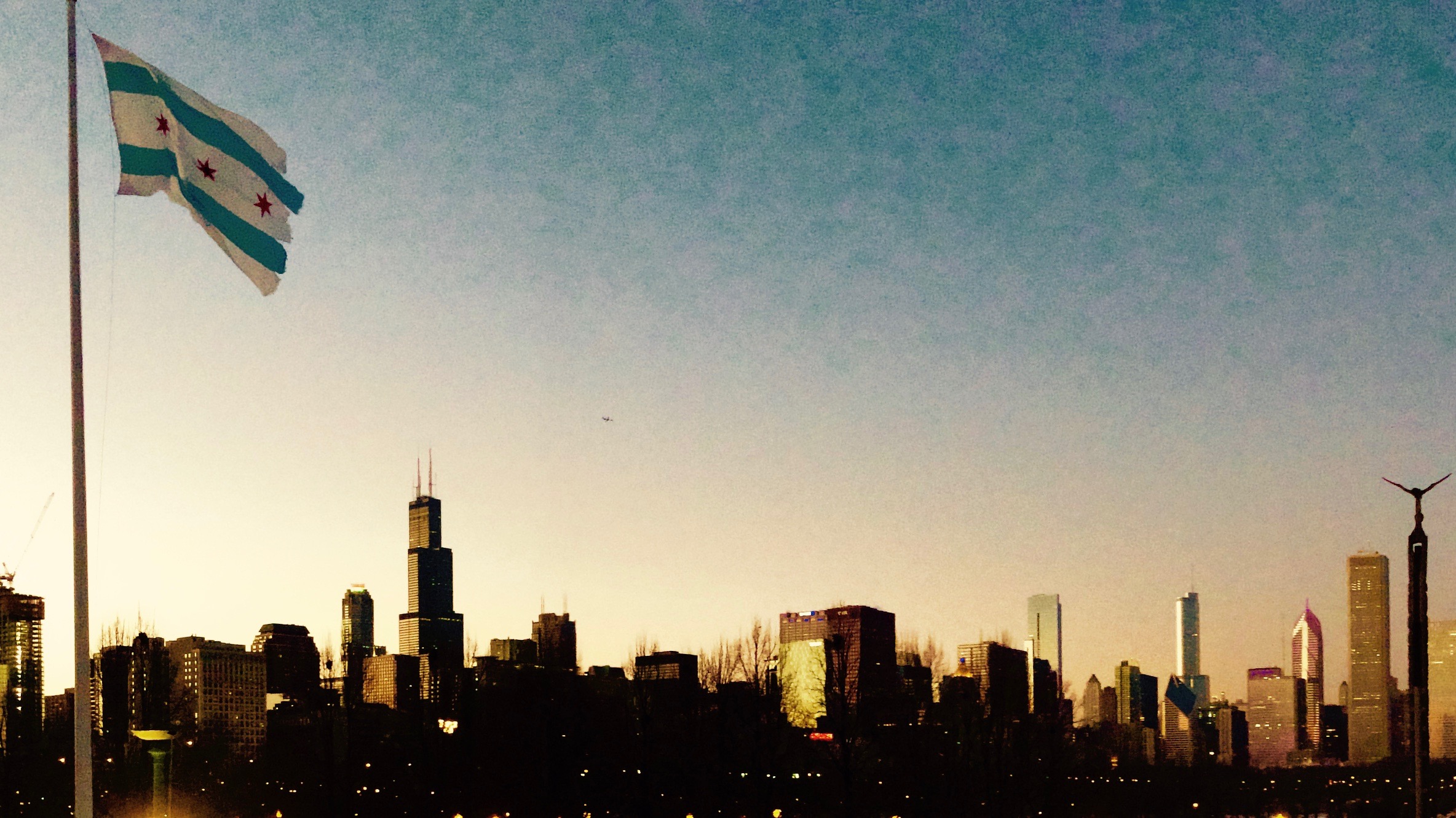 The Chicago skyline beneath the city flag